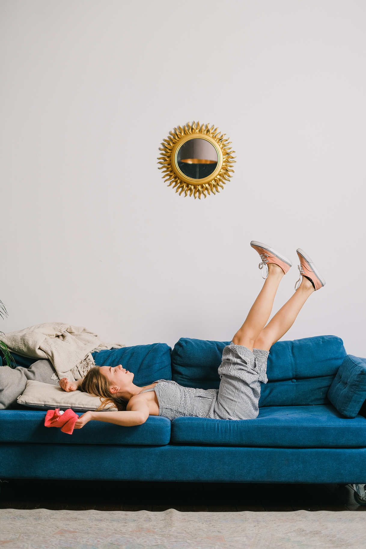 Happy young woman enjoying free time on comfy couch